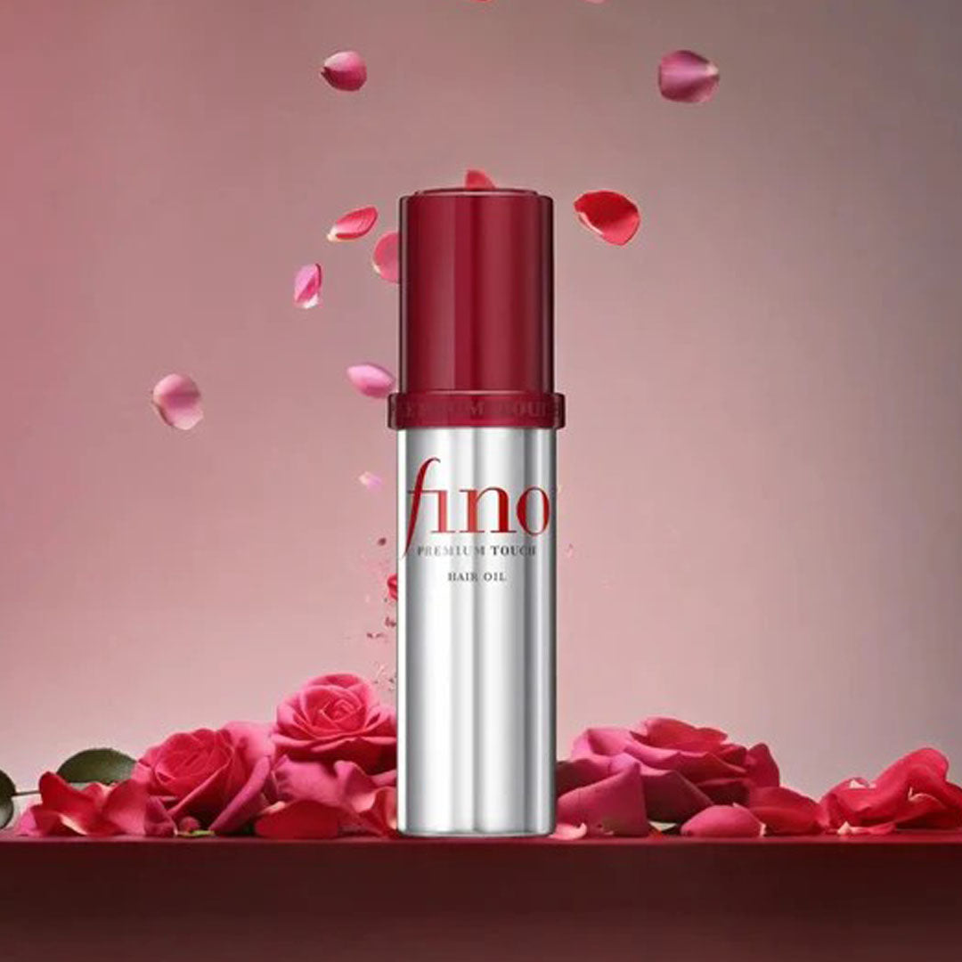 bottle of Fino Premium Touch Intensive Serum Hair Oil with rose petals