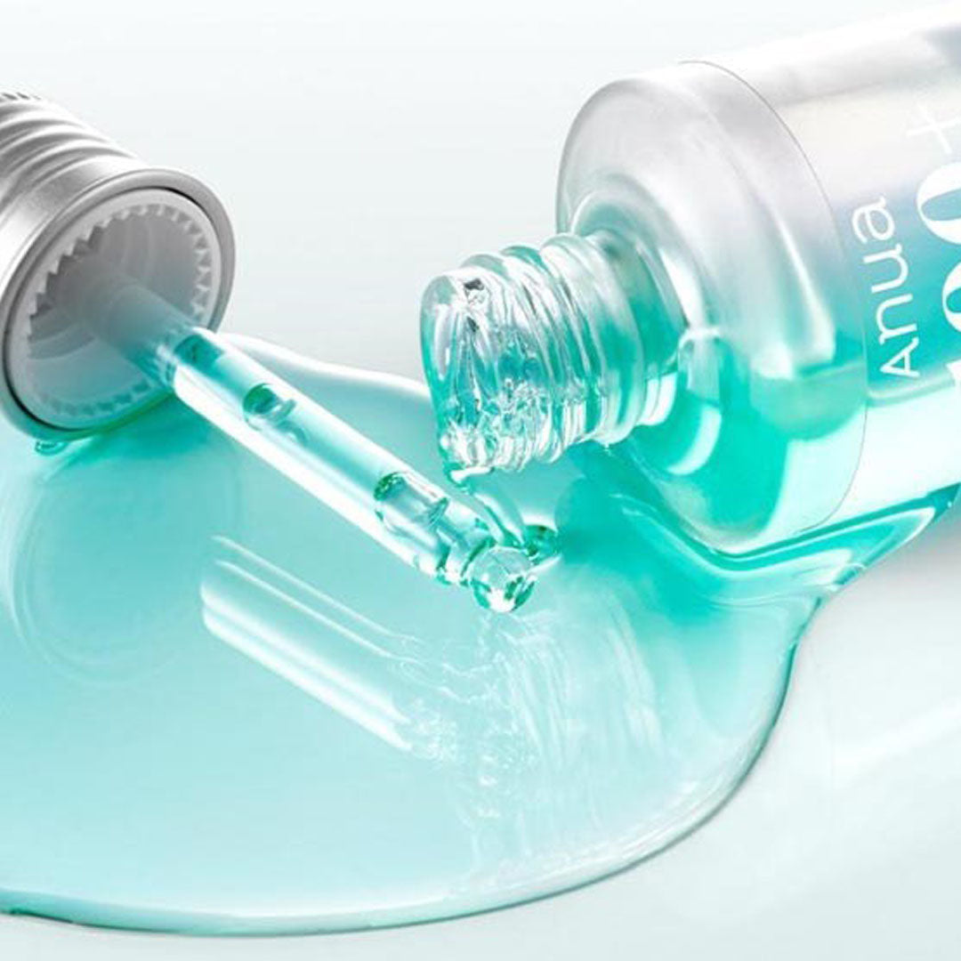 Anua 100+ PDRN + Hyaluron Serum bottle with product dispensed on the surface