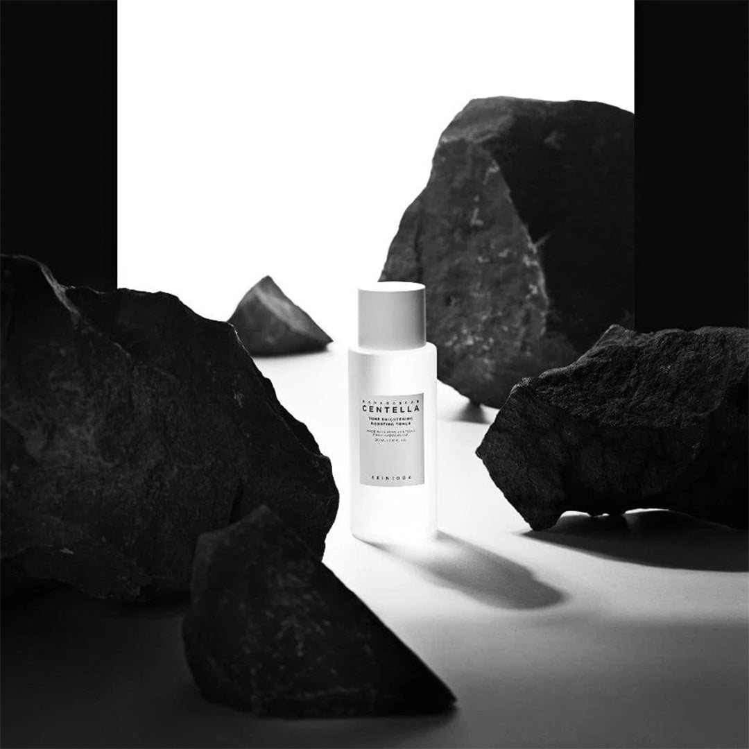 SKIN1004 Madagascar Centella Brightening toner placed in between stones