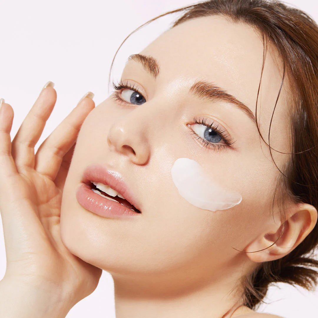 woman with medicube Triple Collagen Cream swatch on her cheek