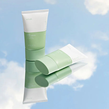 2 Anua Airy Sun Cream Renewed Version tubes on mirror surface