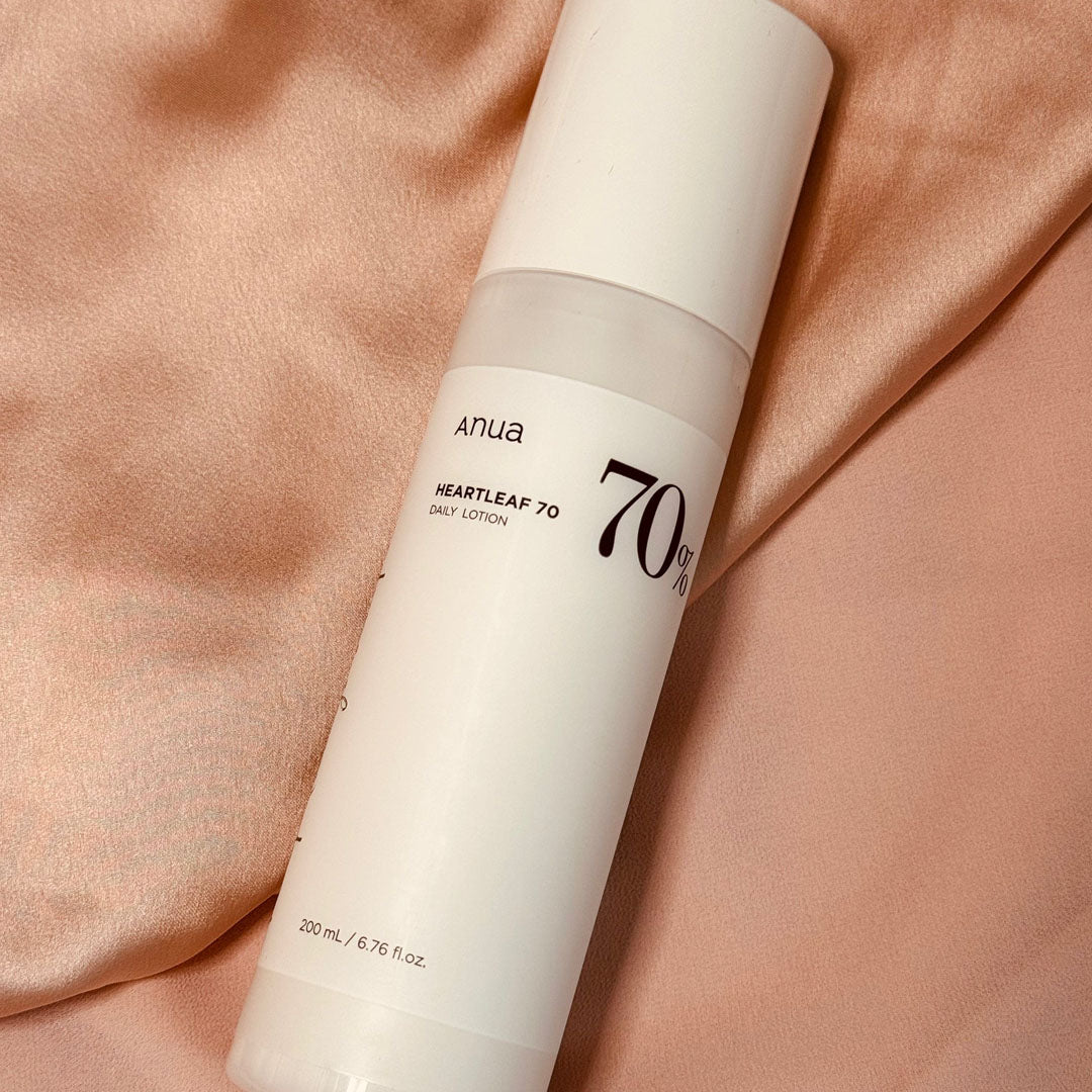Anua Heartleaf 70% Daily Relief Lotion on a silk surface