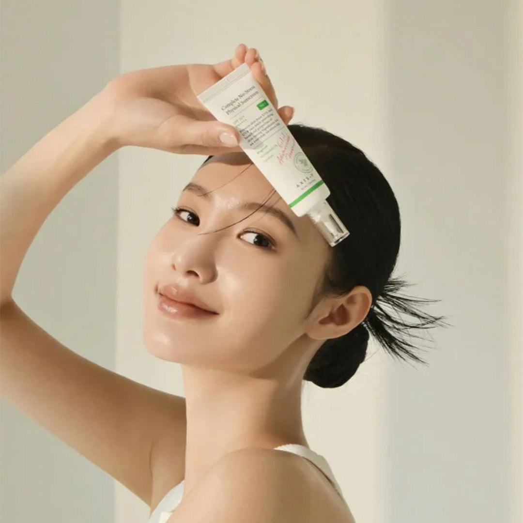 woman holding AXIS-Y Complete No-Stress Physical Sunscreen