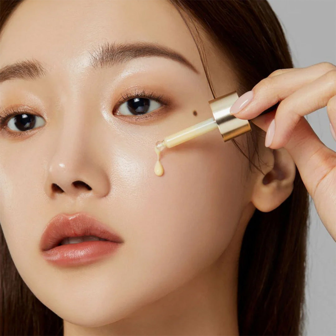 woman applying medicube Deep Vita C Ampoule on her cheek