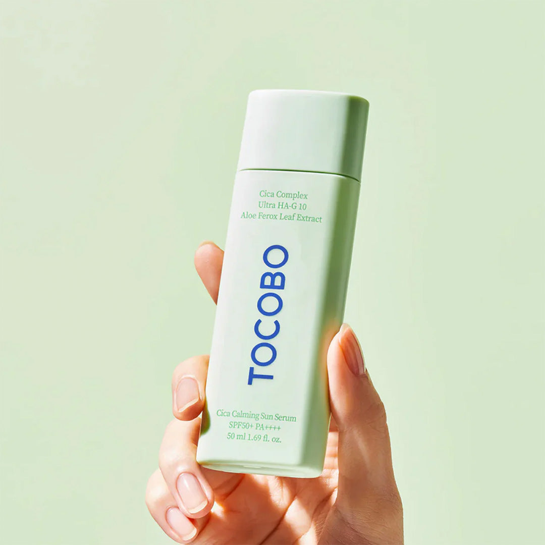 a hand holding TOCOBO Cica Calming Sun Serum