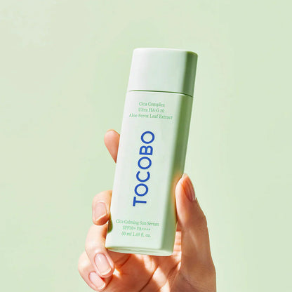 a hand holding TOCOBO Cica Calming Sun Serum