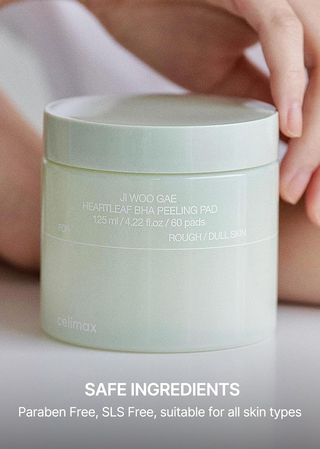 hand touching celimax Ji Woo Gae Heartleaf BHA Peeling Pad jar