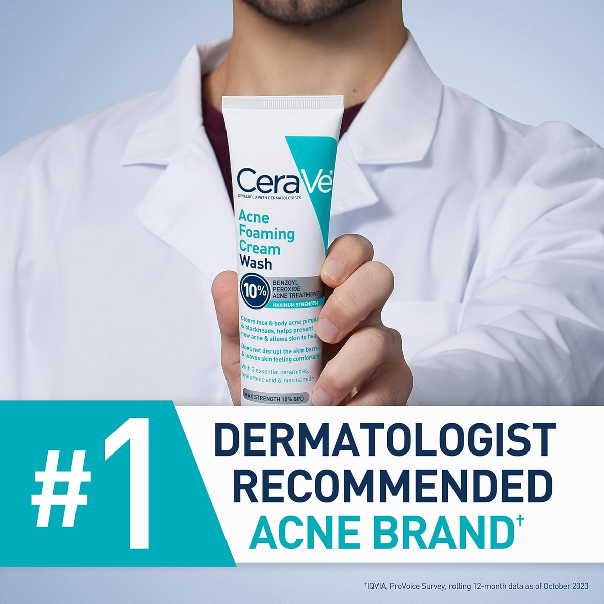 person with a white coat holding CeraVe Acne Foaming Cream Wash tube