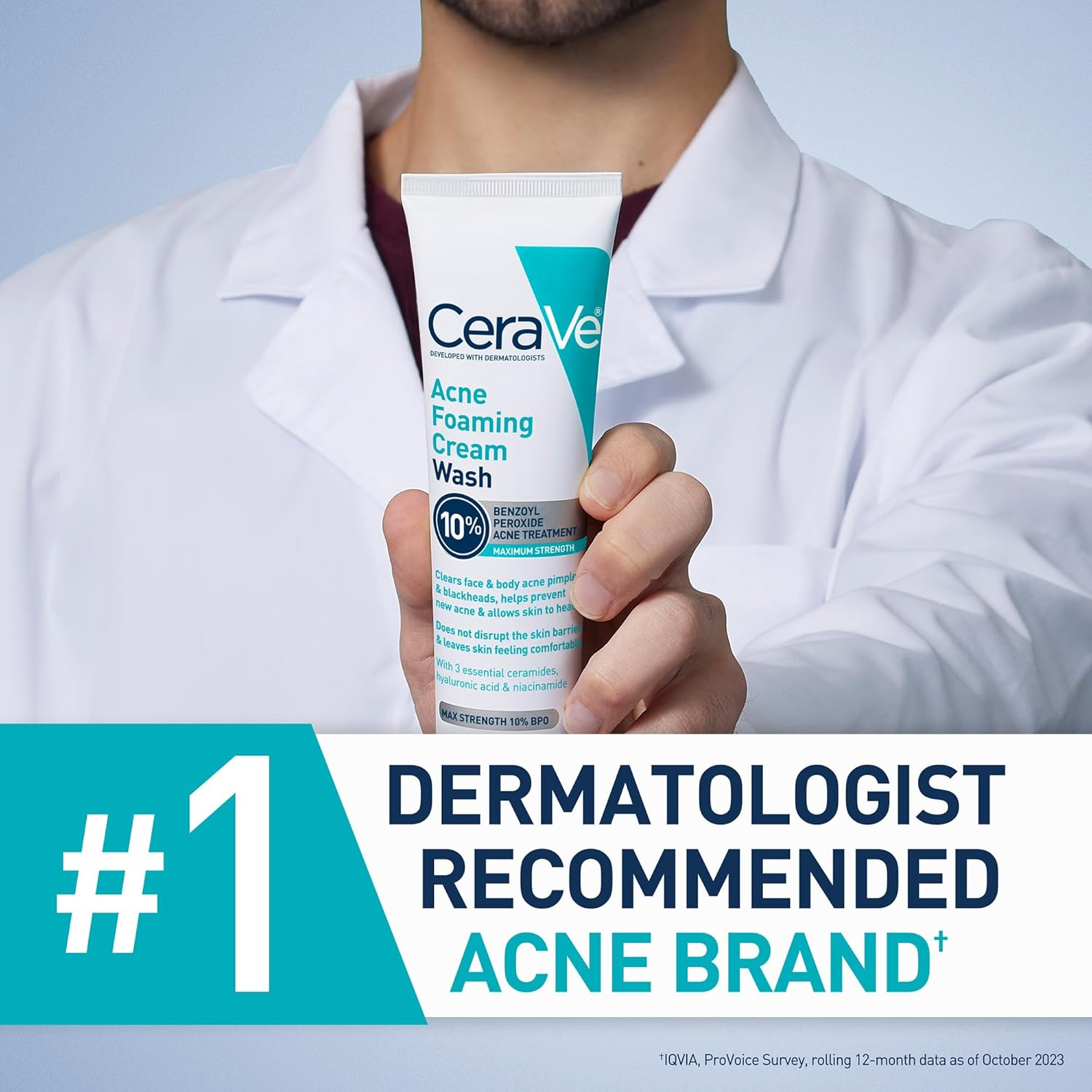 person with a white coat holding CeraVe Acne Foaming Cream Wash tube