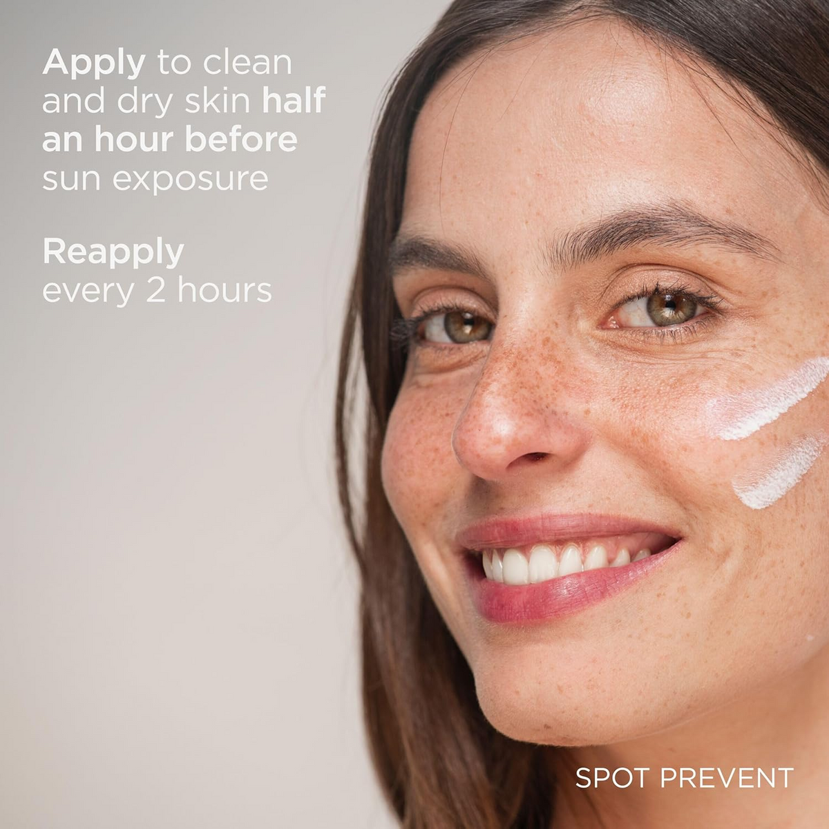 woman smiling with sunscreen on her cheek