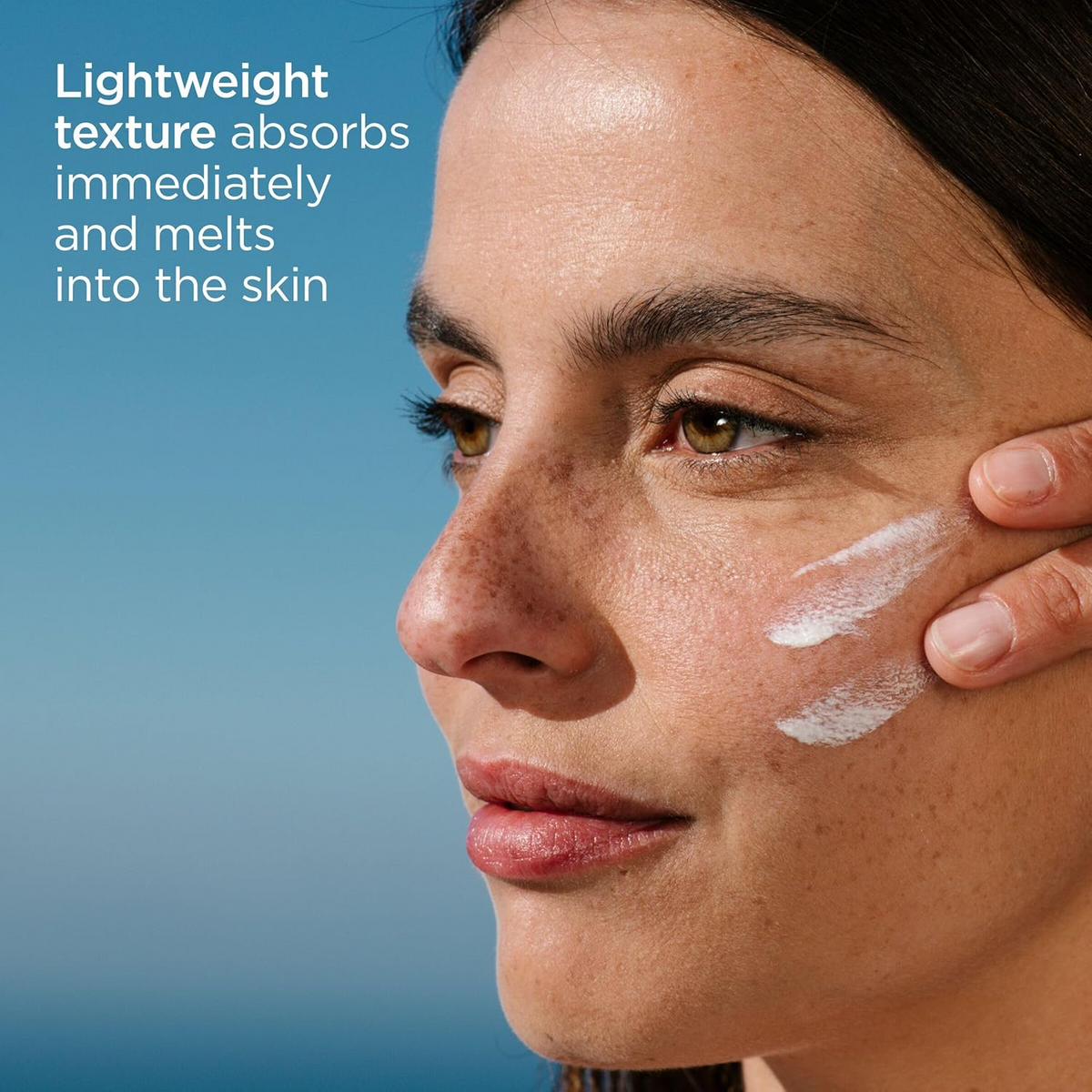 woman applying ISDIN Fotoultra 100 Spot Prevent SPF 50+ on her cheek