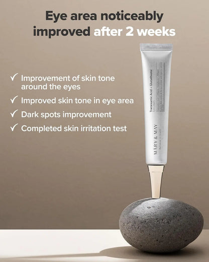 Mary&May Tranexamic Acid + Glutathione Eye Cream 30mL placed upright on a stone 
