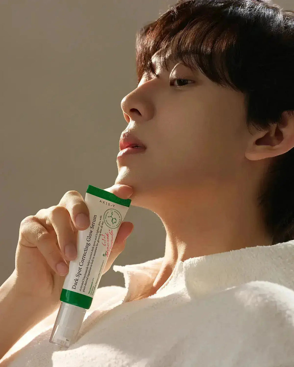 person holding AXIS-Y Vegan Collagen Eye Serum 