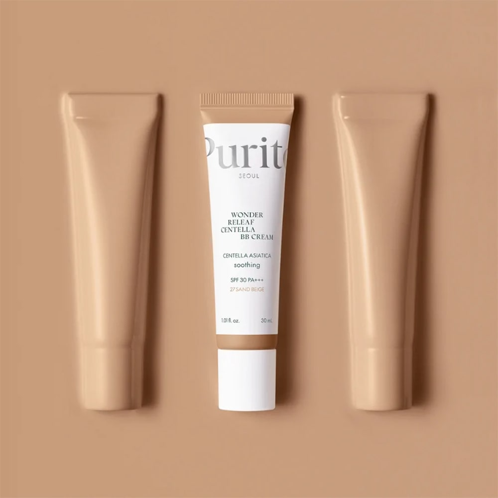 Three BB Cream tubes on a beige background