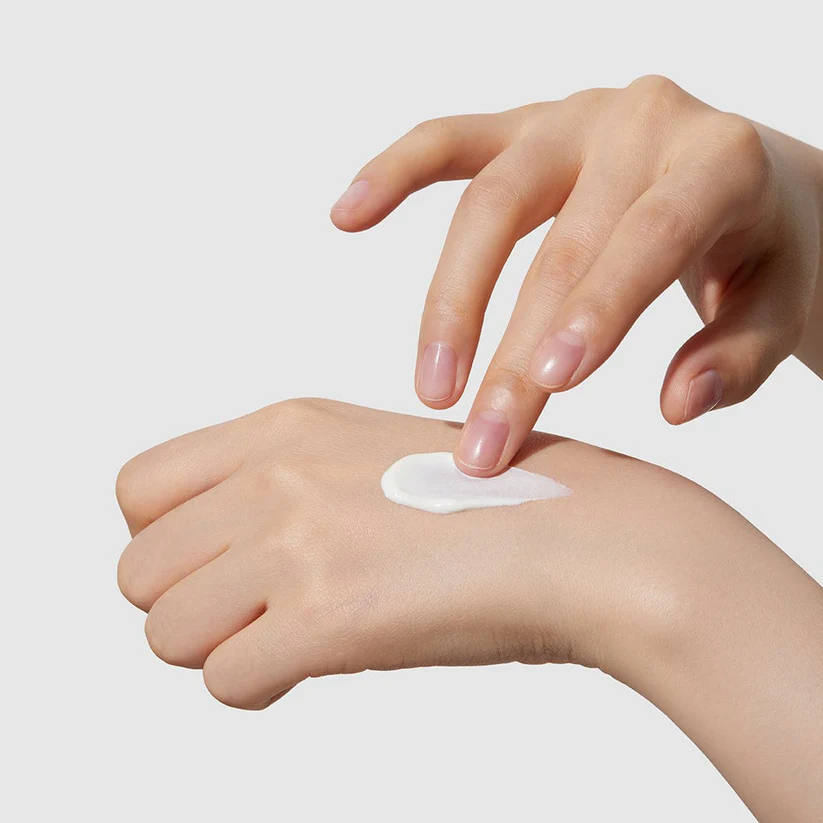 hand applying medicube Red Moisture Real Sun Cream 