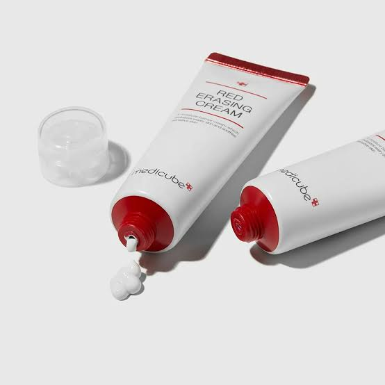 two tubes of medicube Red Erasing Cream with product dispensed out.
